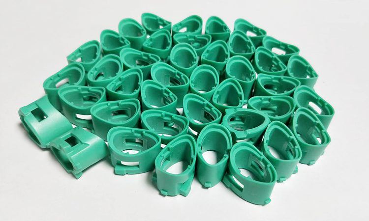 Batch of green cast plastic brackets