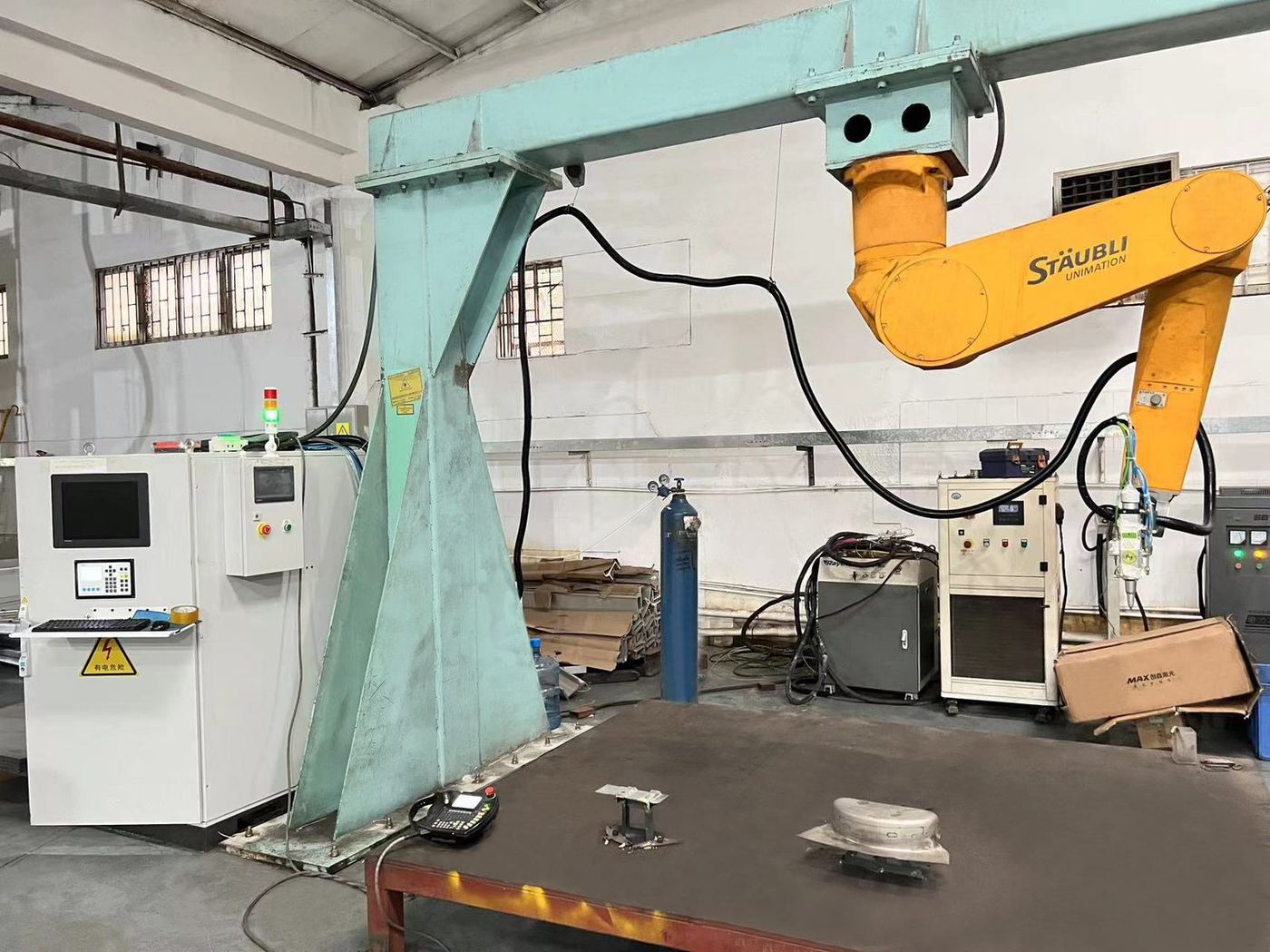 Sheet metal workshop with a robotic welding cell